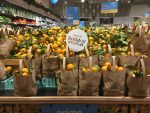 Bright colored oranges stacked in the supermarket with the tag "holiday season"