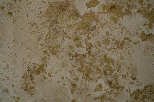 A stone countertop appears rough but is smooth and cool to the touch.