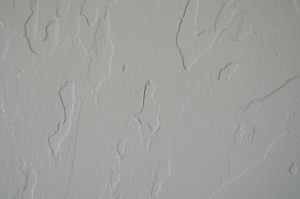 A painted wall on the interior of a bedroom. Smooth, yet pronounced.