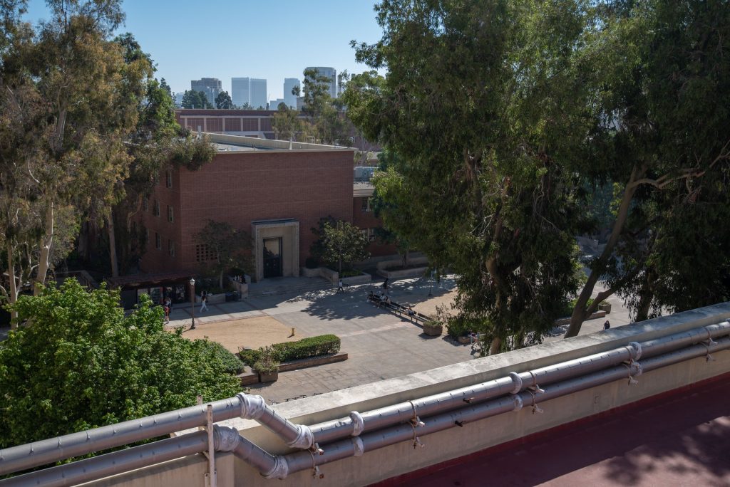 To the east of the roof of Boelter Hall is the Court of Sciences, the very center of south campus. The five-story Geology Building can be seen across the court and the skyscrapers of Los Angeles lie in the background. Photographed by Julia Gu/BruinLife.