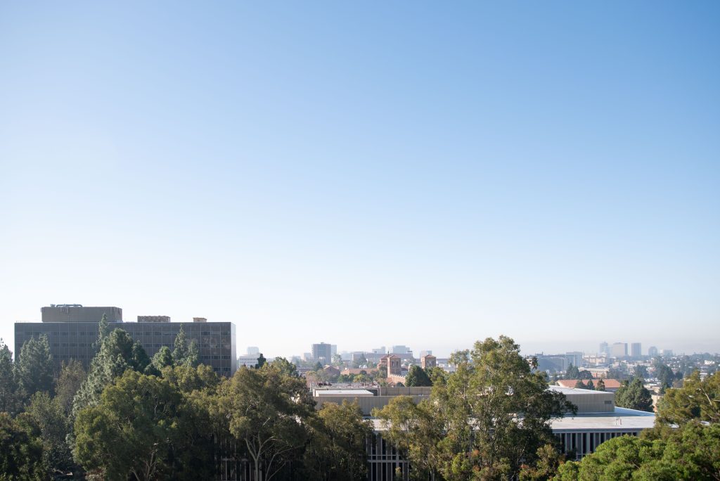 The university and city sunbathe under a blue Los Angeles sky. Bunche Hall to the left, Royce Hall in the center and Santa Monica to the right, the eighth floor of the Broad Art Center offers one of the best vantage points in all of campus. Photographed by Julia Gu/BruinLife.