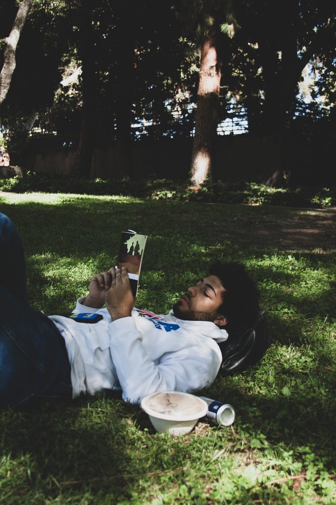 Cameron Wycoff, a fourth-year student majoring in theater, is reading "Of Mice and Men" by John Steinbeck in the Sculpture Garden. “It&squot;s nice to read here &squot;cause it&squot;s so close to all my classes," Wycoff said.