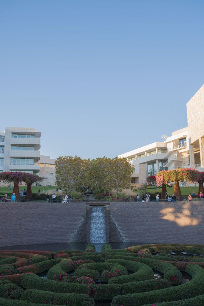 The water fountain draws the eye from the Pavilion buildings down into the heart of the Central Garden's pond. Museum-goers can be seen walking around near the top of the water fountain. Photo by Katelyn Michel/BruinLife.