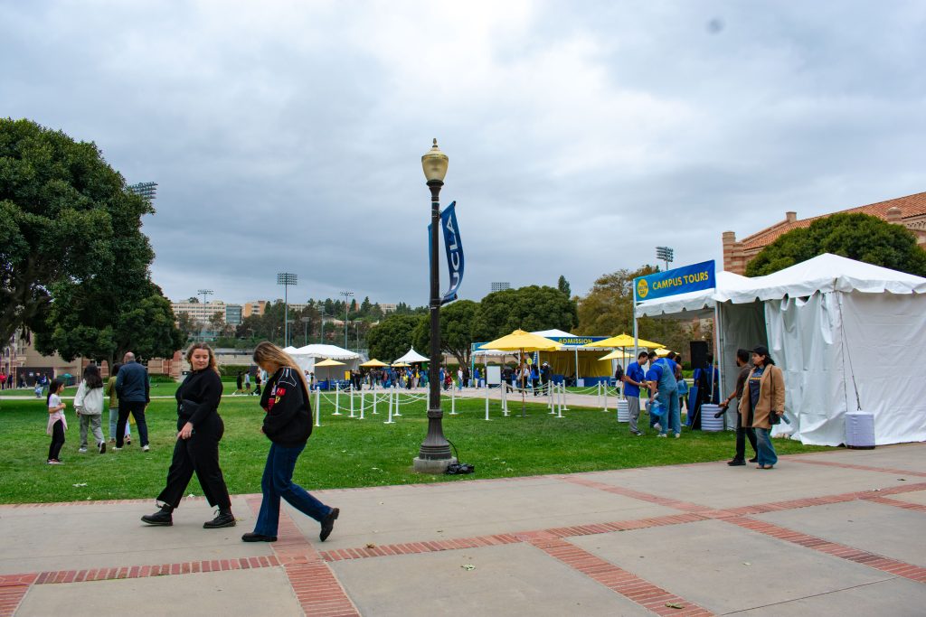 Families walk by campus tour tents set up along Wilson Plaza.