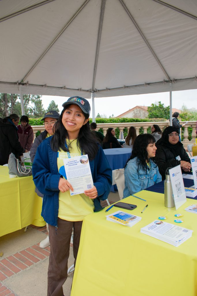 Angelica Sac Tzep, a sophomore majoring in public affairs, works under one of the tents in Dickson Plaza. “It’s been fun. I’ve been here since 8am and it’s been busy all day, the admits seem excited and eager to learn more," Sac Tzep said.