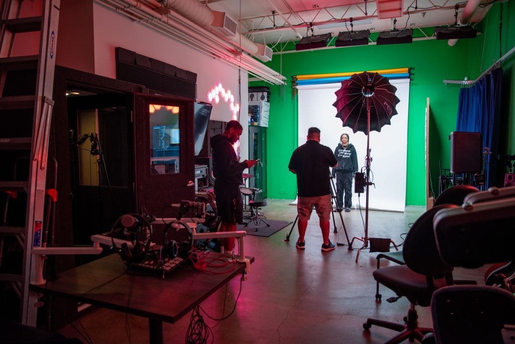 Jasmine Speights, a second-year business economics major, records a short promotion for the Black Bruin Resource Center’s 35th Annual MLK Oratorical. Students take advantage of the green screen in the studio room for projects, both personal and for clubs. Photographed by Julia Gu/BruinLife