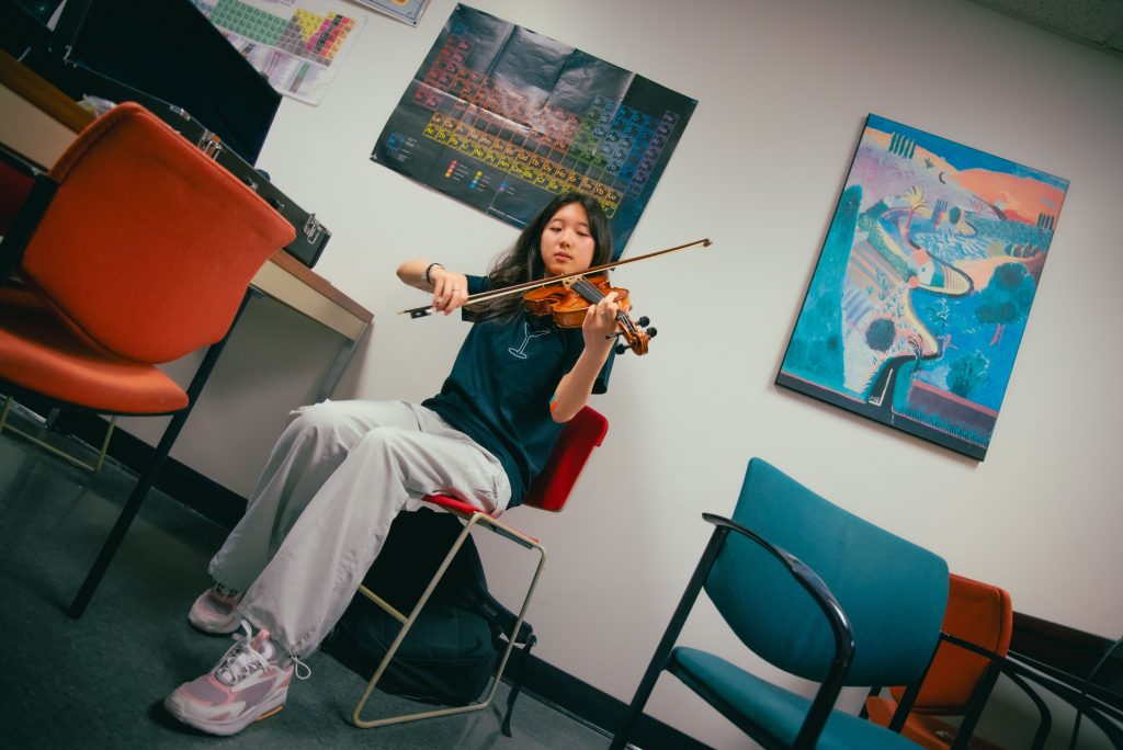 Amber Chen, a first year violinist majoring in English, was originally classically trained but has since shifted to add her strings to The Sinking Ducks. Photographed by BruinLife/Finn Martin