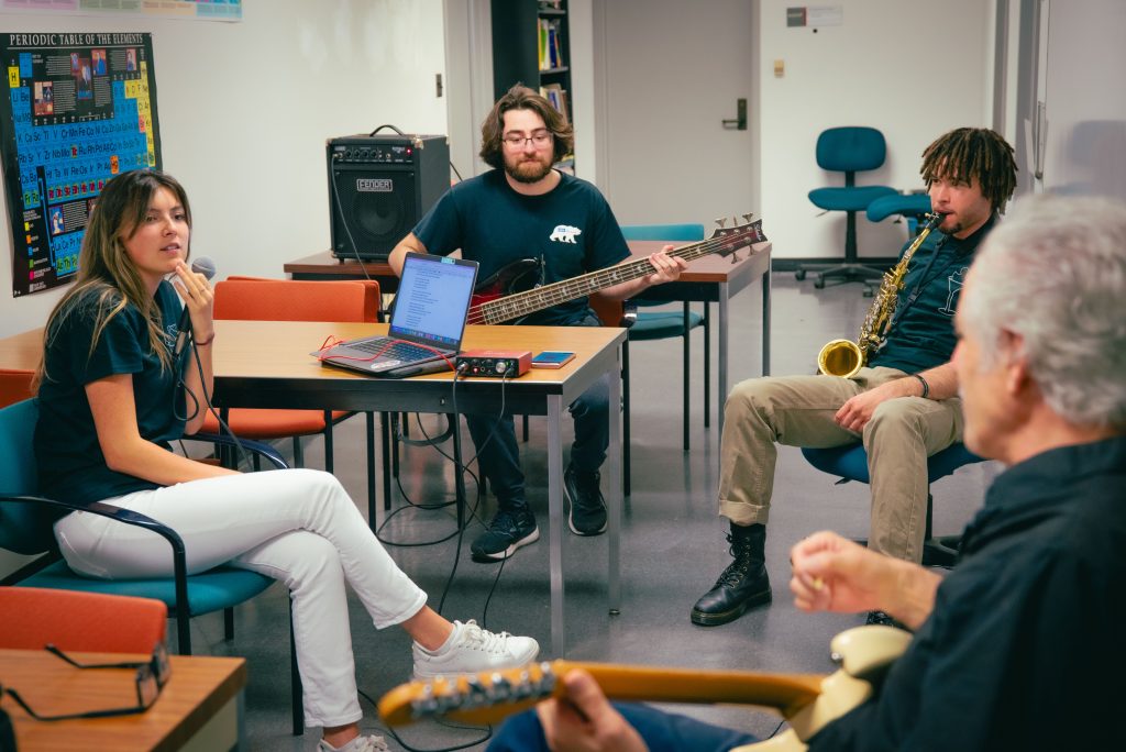 Left to right, Sarah Jane, second year vocalist who has sung for two years, majoring in Physiology and Marine Biology; Jonah Nahoul, a third year MCDB major minoring in Bioinformatics; Stafford Williams, a third year majoring in Neuroscience; Professor Eric Scerri, chemistry professor. Photographed by BruinLife/Finn Martin