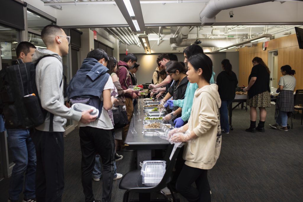 Bruin Dine begins serving the first of the night’s diners. Depending on the amount of food and the number of diners who drop by, food can run out quickly, so diners will often come to the Student Activities Center early to await distribution. Photographed by Julia Gu/BruinLife