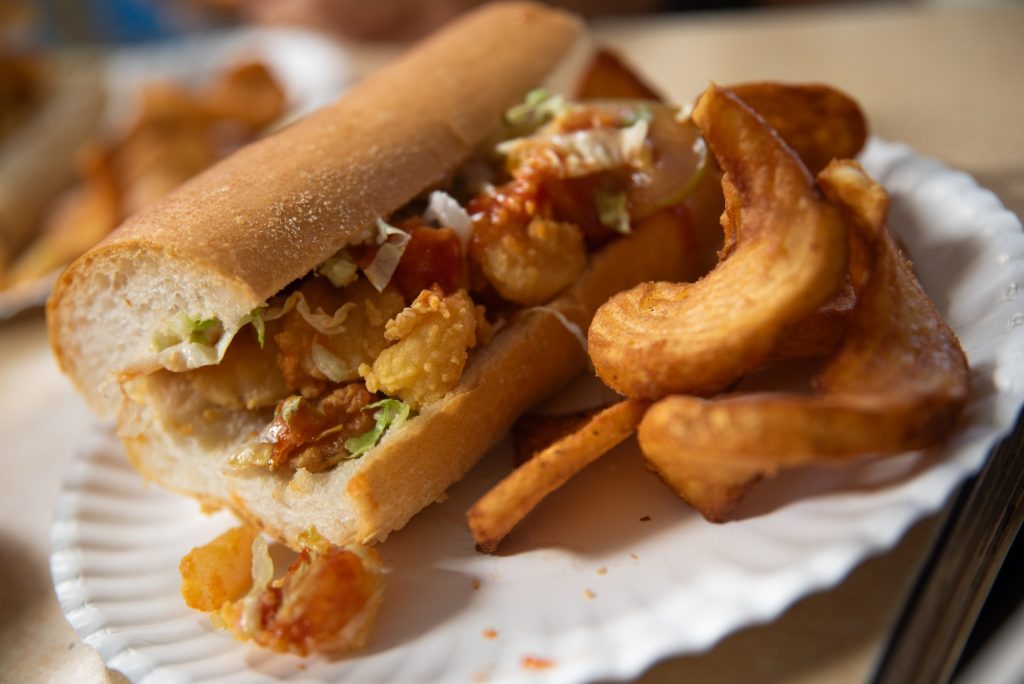 Simple, fresh and delicately dressed: Domilise's offers a Po-Boy and curly fry combination in a cozy, hometown feeling setting. Photographed by Finn Martin/BruinLife.