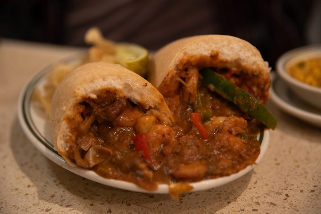 Living up to its name, the Gumbo Shop applies its gumbo specialize to its Po-Boy sandwiches. Here is plated the Sautéed Shrimp Po-Boy. Photographed by Finn Martin/BruinLife.