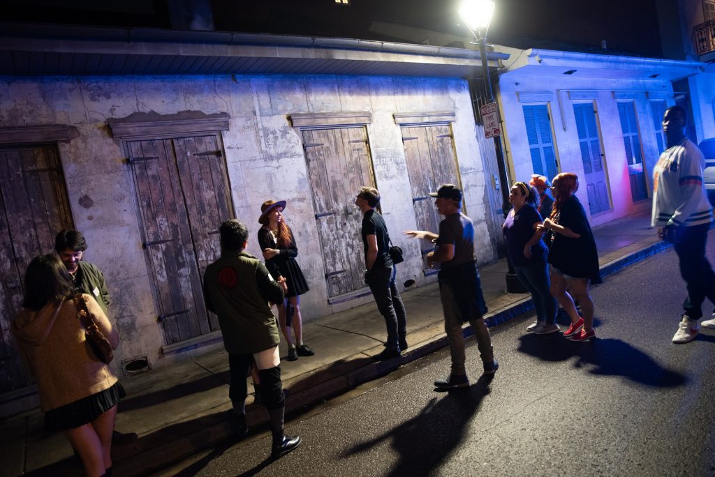 Tour guide Dane points to an old tenement home near Toulouse Street in New Orleans. Photographed by Finn Martin/BruinLife.