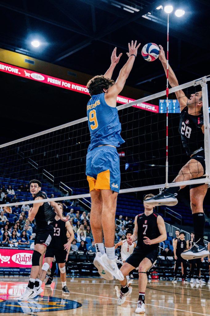 Freshman setter Trent Taliaferro goes up for the block against Stanford's offense and shuts down the attack. Photographed by Cathryn Kuczynski/BruinLife.
