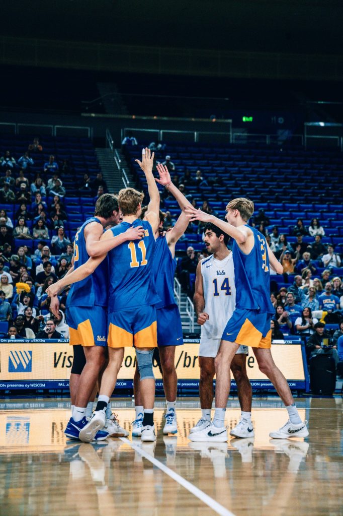 The Bruins celebrate their victory against the Stanford Cardinal at the end of the third set. Photographed by Cathryn Kuczynski/BruinLife.
