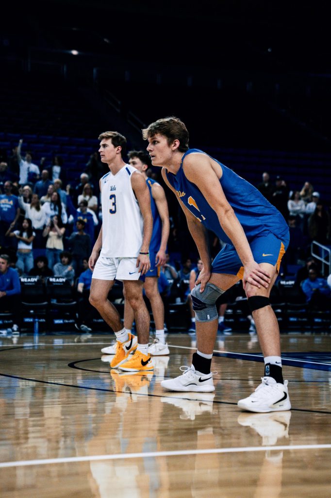 Cooper Robinson and Luca Curci wait in serve-receive as they anticipate Stanford's serve. Photographed by Cathryn Kuczynski/BruinLife.