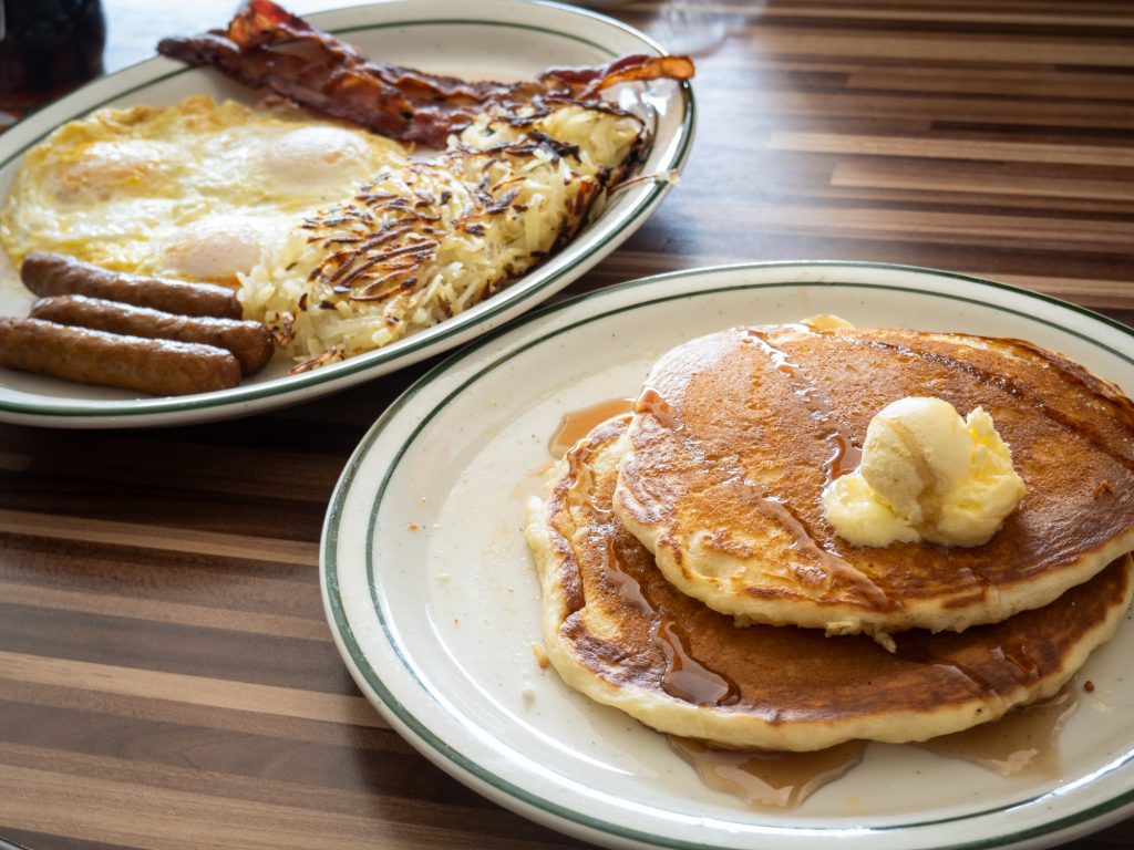 The Lumberjack Breakfast will plate more than enough energy before you to get you through your day -- the combo meal is served in triplets: hotcakes, eggs, bacon, sausage, and hash browns. Photographed by Finn Martin/BruinLife