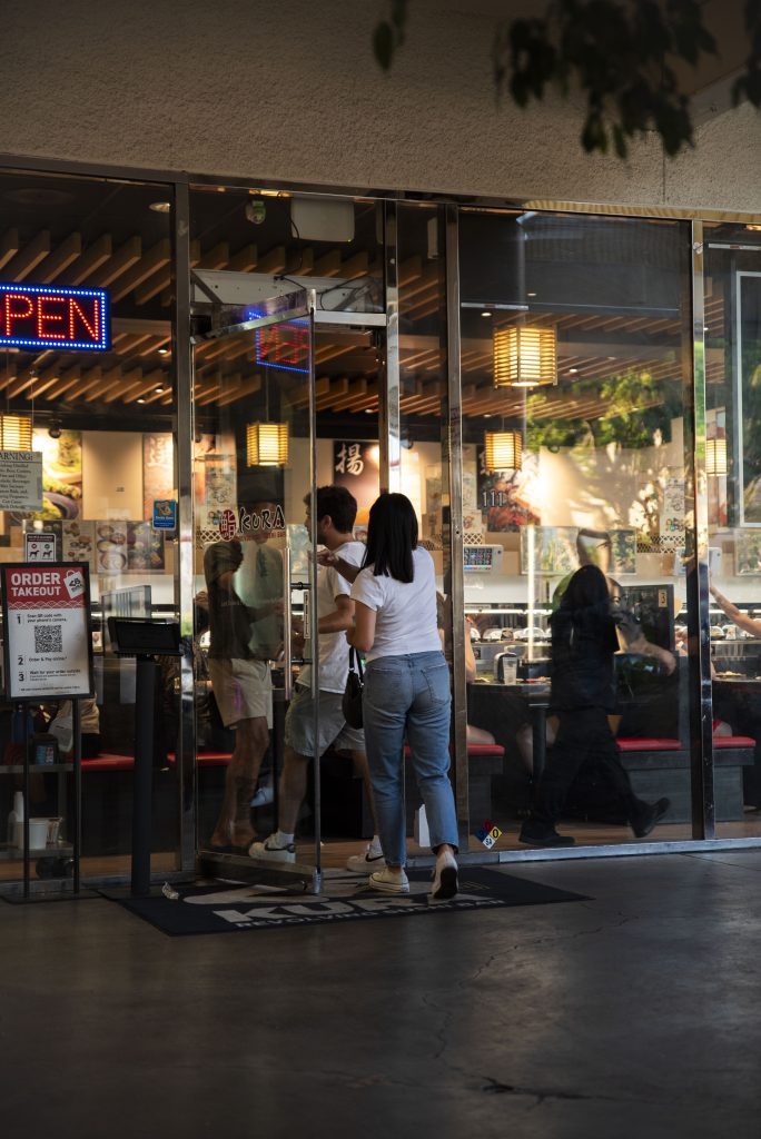 Customers are called in to the restaurant after waiting for some time. Kura Revolving Sushi Bar often has longer wait times, but offers a unique dining experience. Photographed by Emily Chandler/BruinLife.
