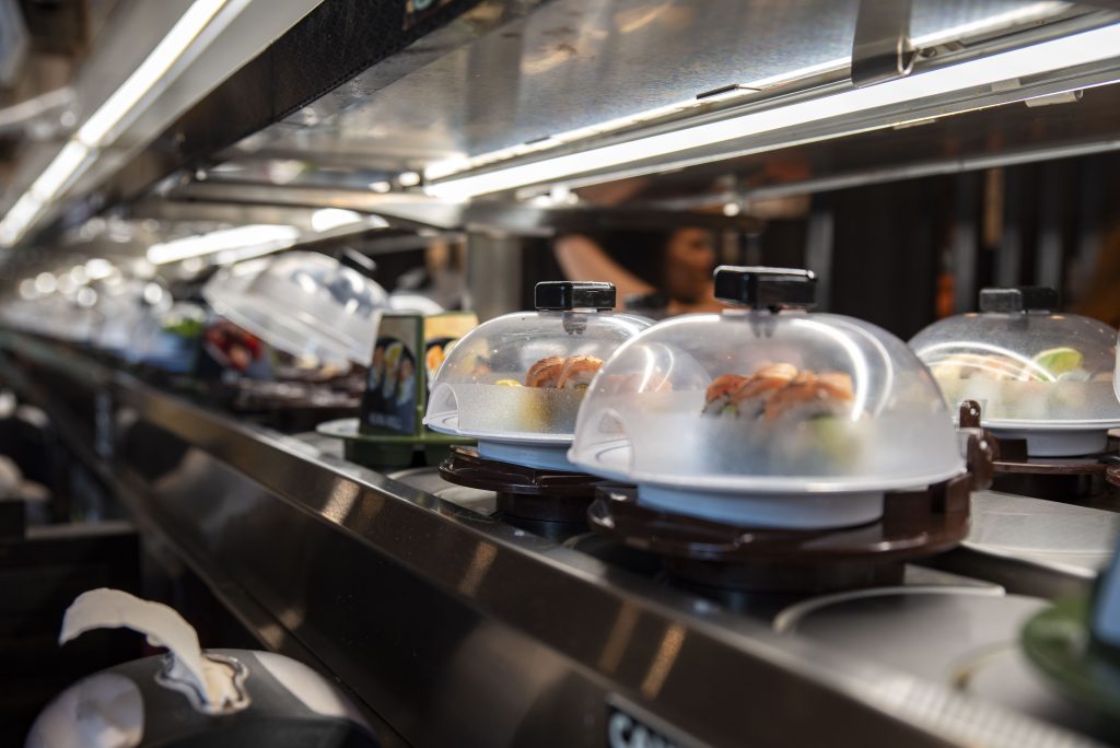 A variety of sushi is placed on the rotating conveyer belt and traveled through the restaurant for customers to reach for. Photographed by Emily Chandler/BruinLife.