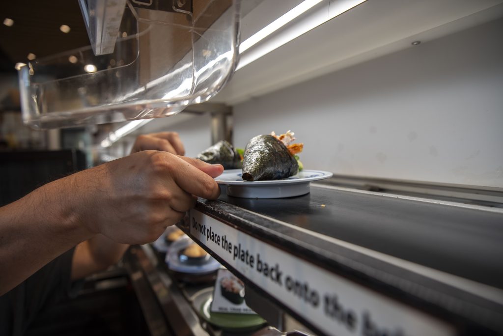 Hand rolls are delivered on a separate belt after being ordered through the tablet. Photographed by Emily Chandler/BruinLife.