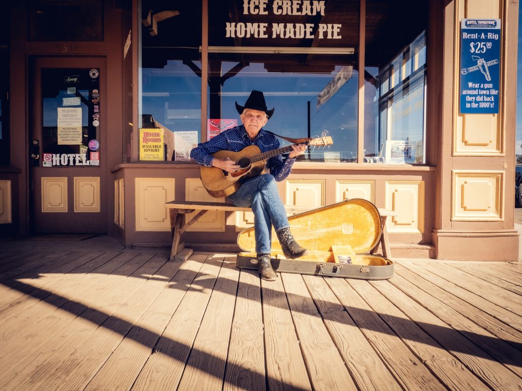 Born in a town not so far away, W.D. "Arizona" Kennedy often can be found playing a track of original and classic Western tunes at a Tombstone street corner. Search for him playing in town on Google Maps street view to see how long he&squot;s been playing here. Photographed by Finn Martin/BruinLife.