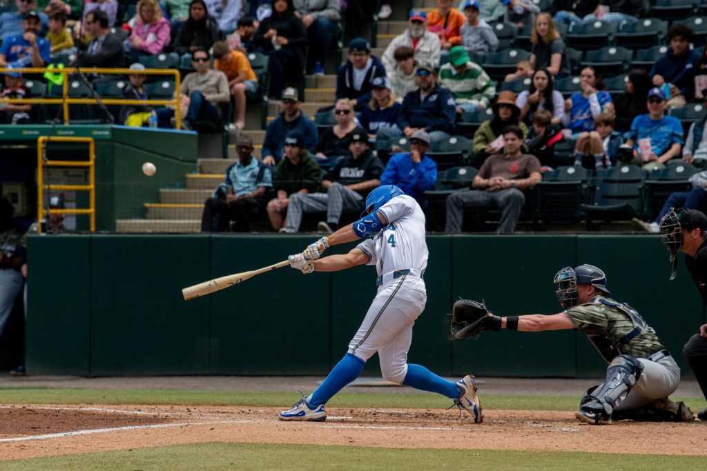 #4 infielder, Phoenix Call, connects with the pitch for a base hit. Photographed by Maia Salti/BruinLife