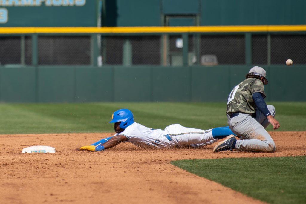#36 Dean West dives headfirst into second base, beating the tag to stay safe. Photographed by Maia Salti/BruinLife