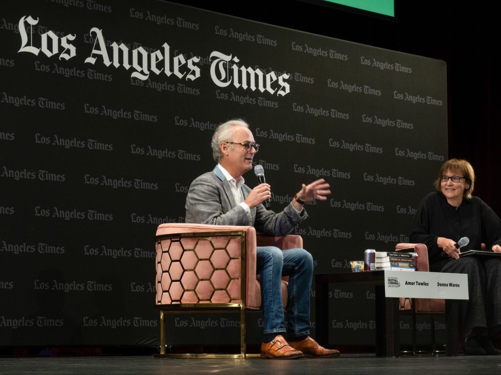 Amor Towles waves in his eager crowd of listeners while in conversation with Donna Wares. Photographed by Finn Martin/BruinLife.