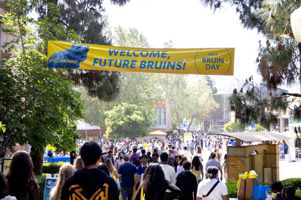 A bright yellow banner fetes the admission of UCLA's class of 2029. Normally empty on a Saturday afternoon, UCLA campus was full of life this weekend, with the Bruin bear bathing gladly in the attention. Photographed by Julia Gu/BruinLife.