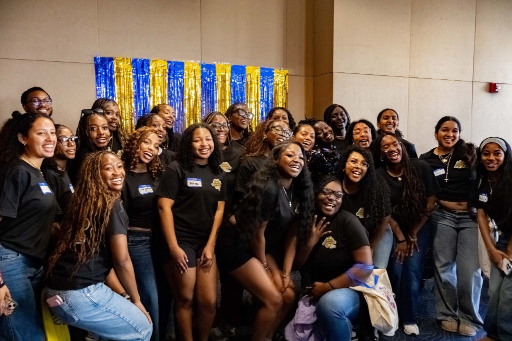 Volunteers for the Black by Popular Demand Admit Weekend pose for a group photo in front of a UCLA-themed photo wall. The event has been hosted by the UCLA Black Alumni Association annually to welcome students of the Afrikan diaspora and celebrate shared cultural roots since 2004. Photographed by Julia Gu/BruinLife.