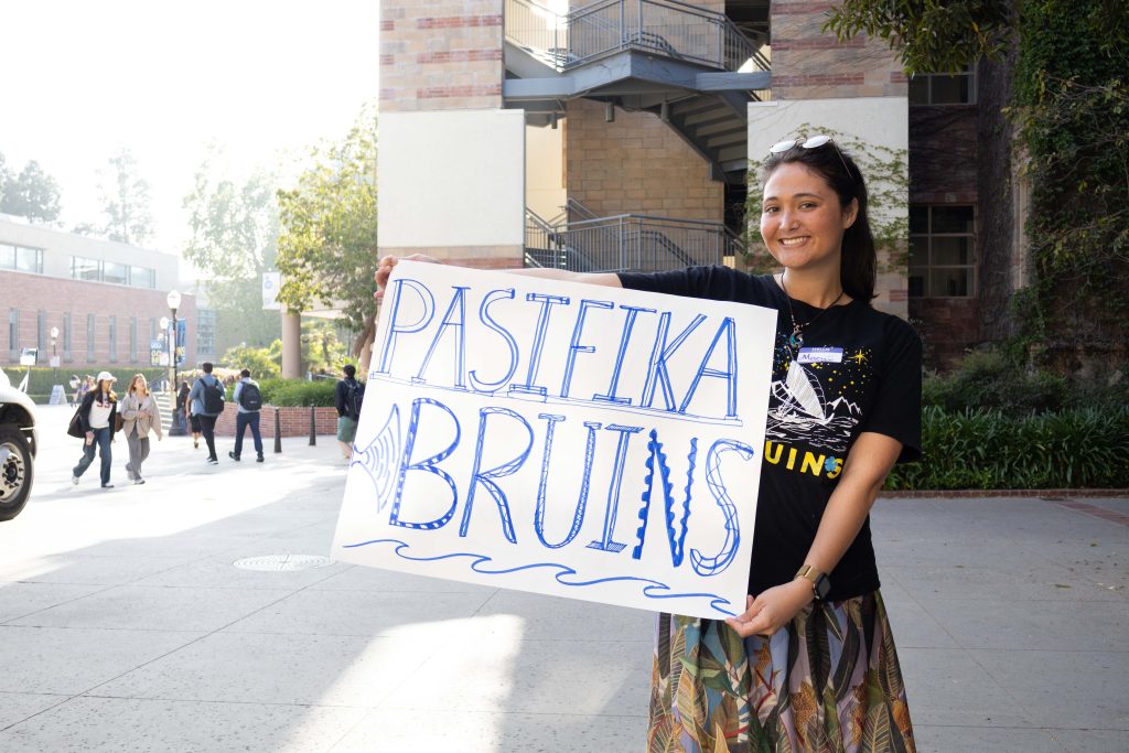 Macy from the Pacific Islands' Student Association (PISA) advertises an event with speakers and food from a great number of Polynesian cuisines. The Freshmen Admit Weekend is one of PISA's five annual events, bringing admitted Pacific Islands students and families together to celebrate a shared heritage and experience at UCLA. Photographed by Julia Gu/BruinLife.