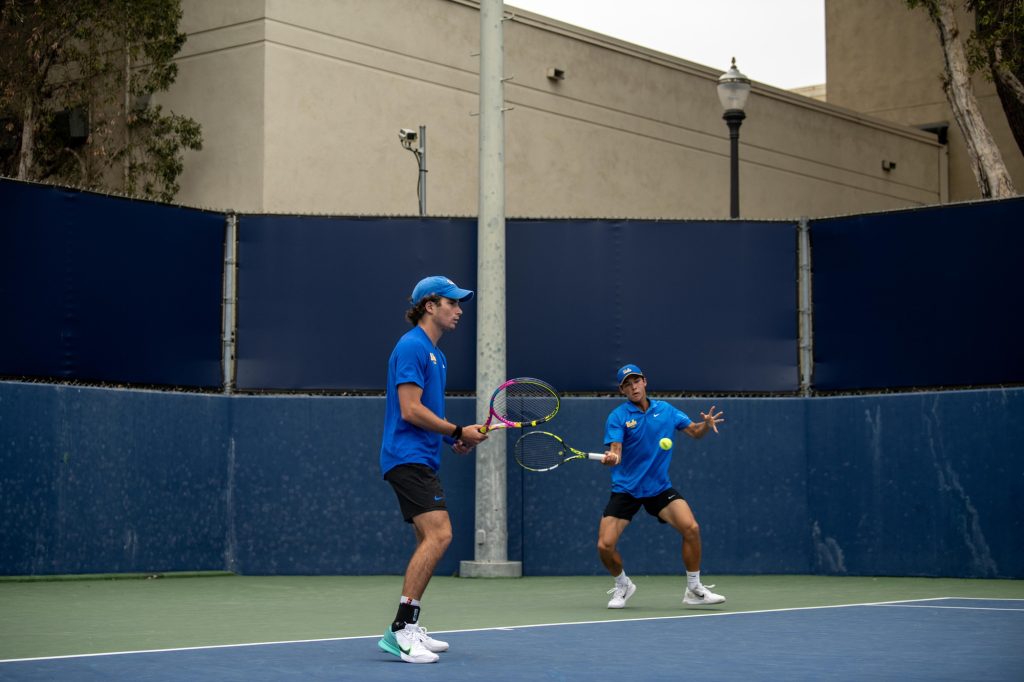 Emon van Loben Sels is ready to strike the ball in doubles match with partner Gianluca Ballotta. Photographed by Mira Daya/BruinLife