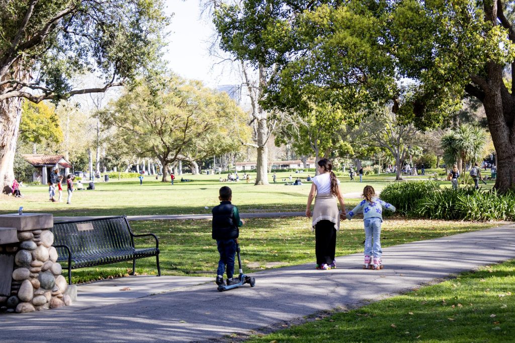 A trio circles the park on wheels. Photographed by Julia Gu/BruinLife.