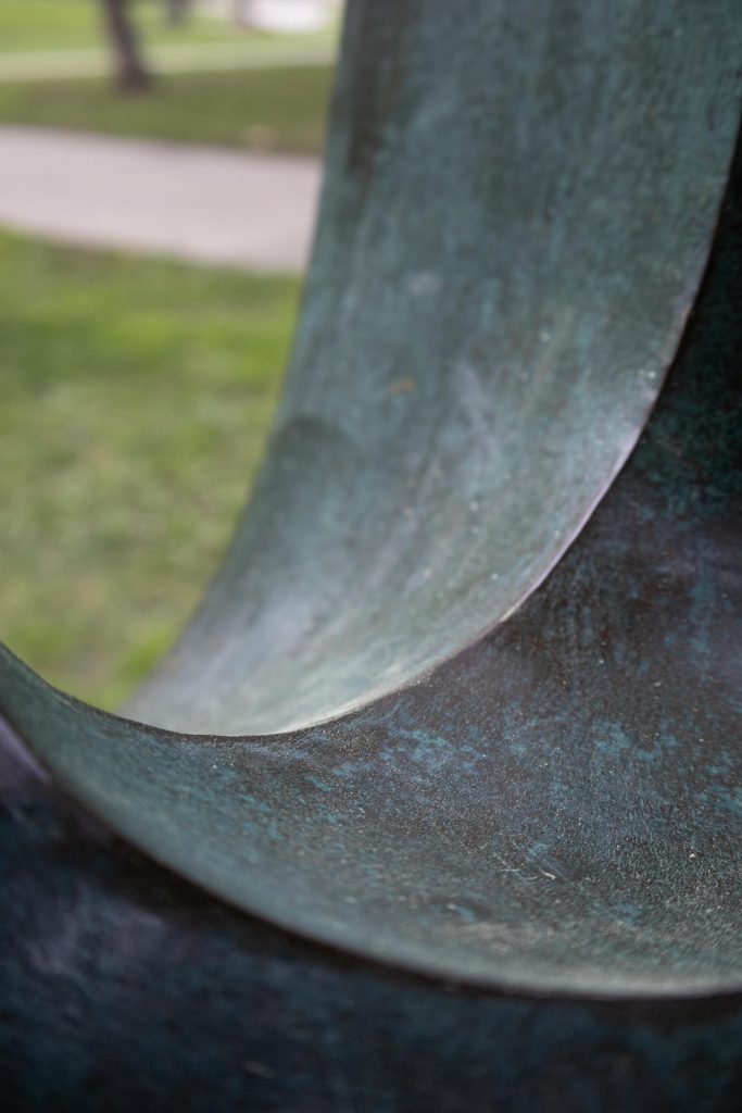 Detail on Elegy III, a 1966 piece by English sculptor Barbara Hepworth. With Modernistic influences, the sculpture is a smooth oval form with three hollowed faces that meet in the center. Photographed by Julia Gu/BruinLife.