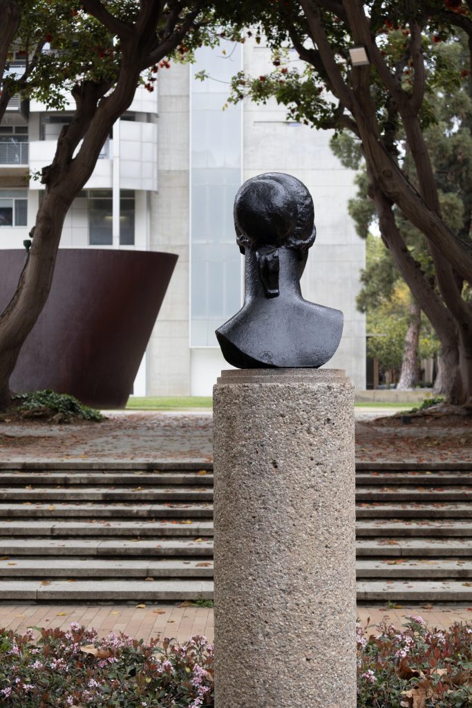A bust gazes towards the Broad Art Center. Created by French sculptor Aristide Maillol in 1923, Heroic Head now stands in memory of Mary E. Freiberg, a respected former member of the UCLA Arts Council. Photographed by Julia Gu/BruinLife.