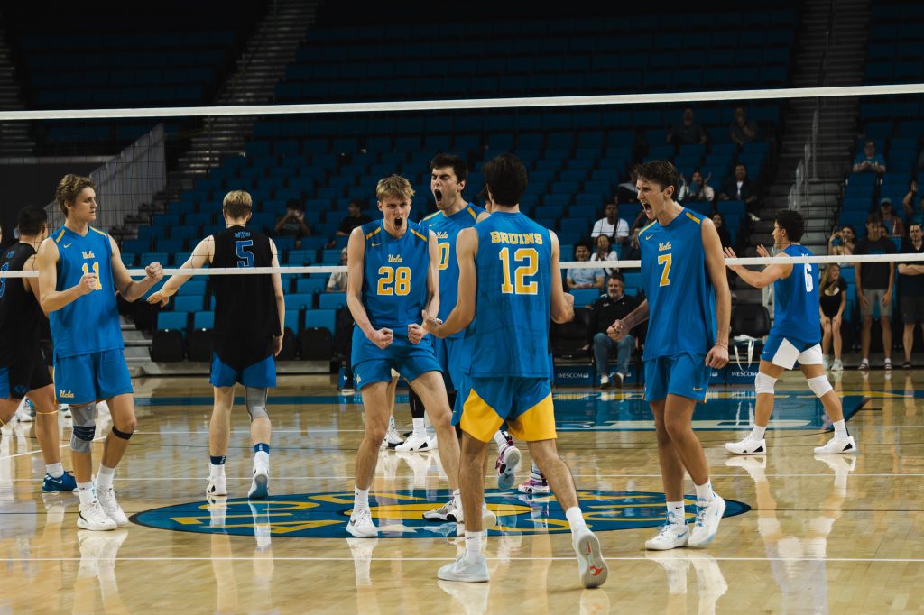 The team screams in celebration after earning the point after an extended rally. Photographed by Cathryn Kuczynski/Bruinlife.
