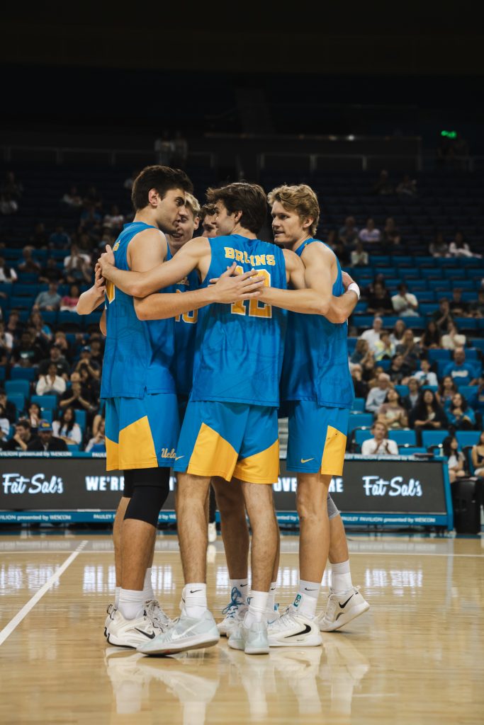 The UCLA Men's Volleyball Team embraces after earning the point in the second set of the match. Photographed by Cathryn Kuczynski/Bruinlife.