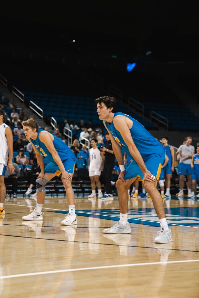Freshman Sean Kelly and redshirt junior Cooper Robinson prepare for the serve from BYU. Photographed by Cathryn Kuczynski/BruinLife.