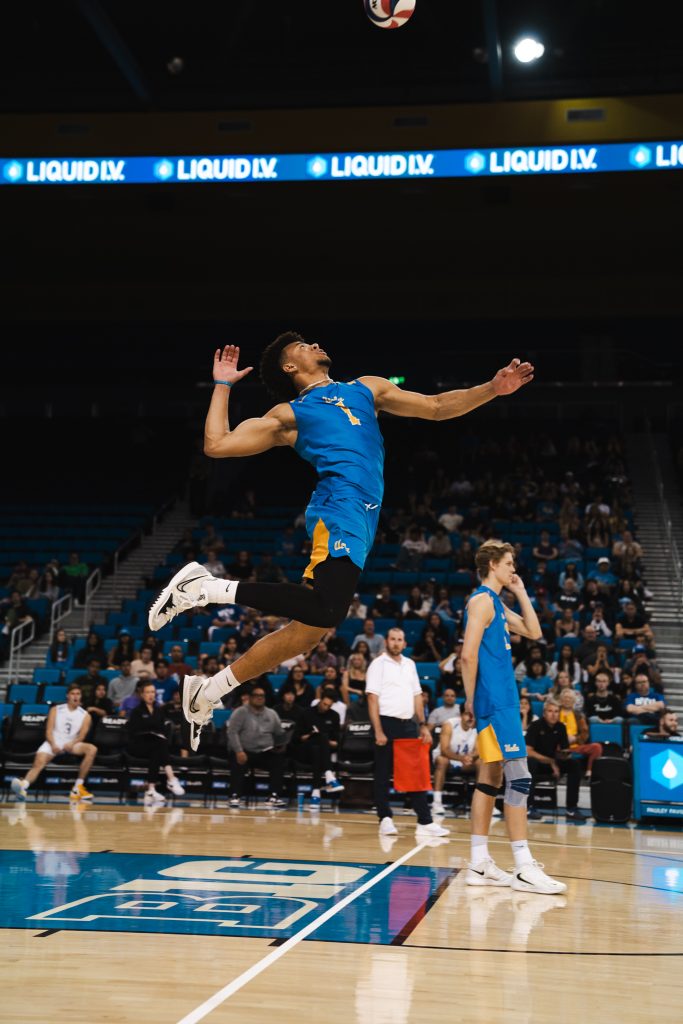 Middle Blocker Cameron Thorne jump serves the ball, kicking off the rally against opponent BYU. Photographed by Cathryn Kuczynski/Bruinlife.