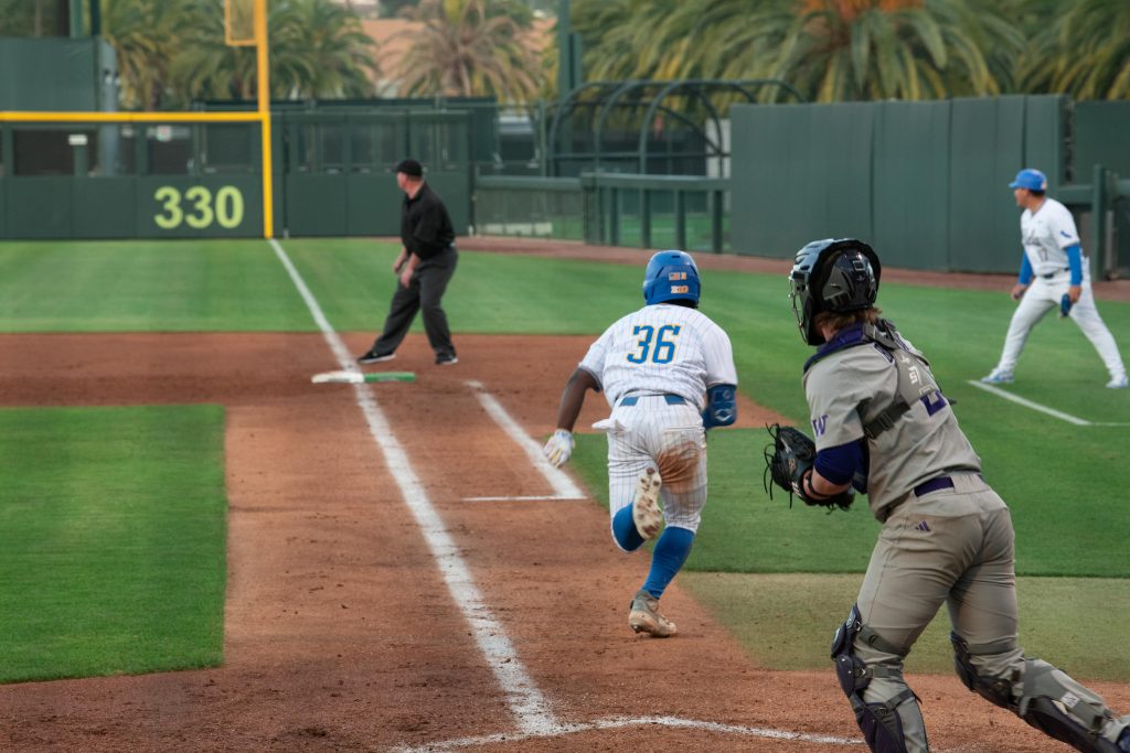 UCLA's outfielder Dean West, no.35, runs down first baseline after hitting a line drive towards left field.