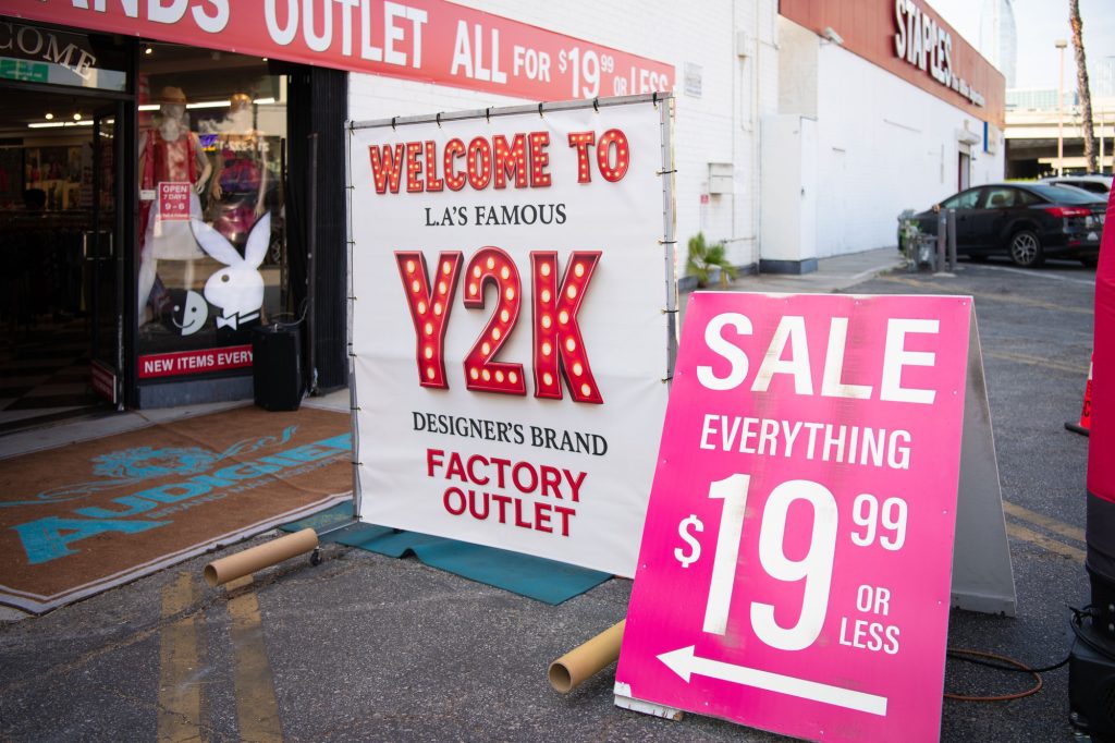 Welcome to Y2K sign and sale sign placed outside entrance of store.