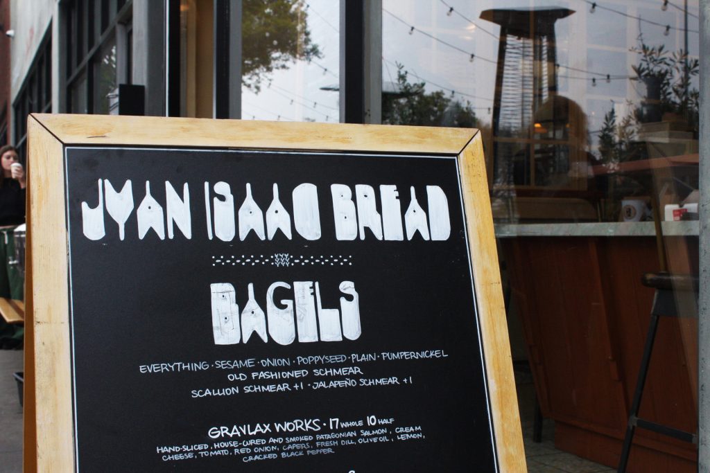 Stepping onto Ocean Park Boulevard's restaurant-lined sidewalk, passersby will come across Jyan Isaac's quaint bagel advertisement. Photo by Gavin Meichelbock.