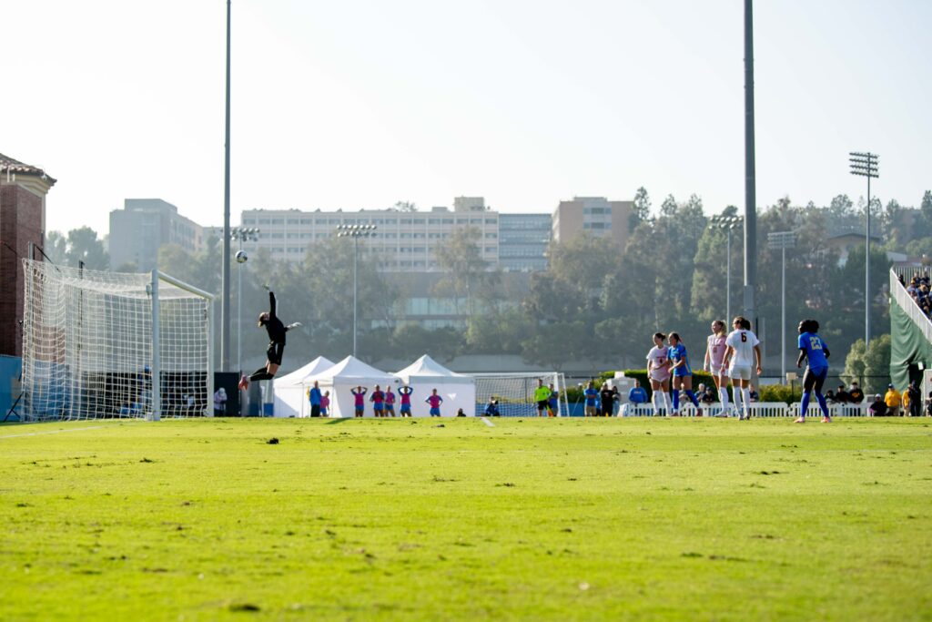 Trojan goalkeeper Bella Grust jumps to block a shot by the Bruins. With a strong Bruin offense, Grust totaled 7 saves in the rivalry game. Photographed by Julia Gu/BruinLife.