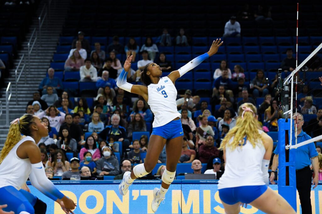 Star prospect from Hampton Georgia, Cheridyn Leverette, jumps high to swing ball over net, splitting the Maryland defense. Photo by Luana Caravalho