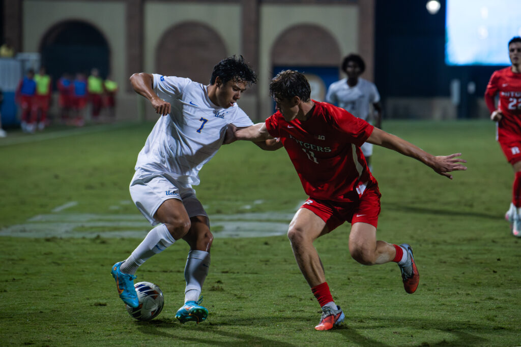 Player #7, Midfielder Philip Naef, juggles the ball when trying to take it from the Rutger's defenders.