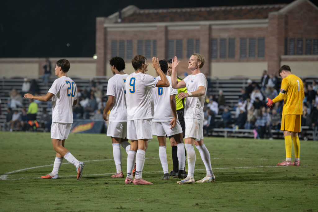 Sergi Solans and Oliver Roche applaud each other's support in scoring goals for the UCLA men's soccer team.
