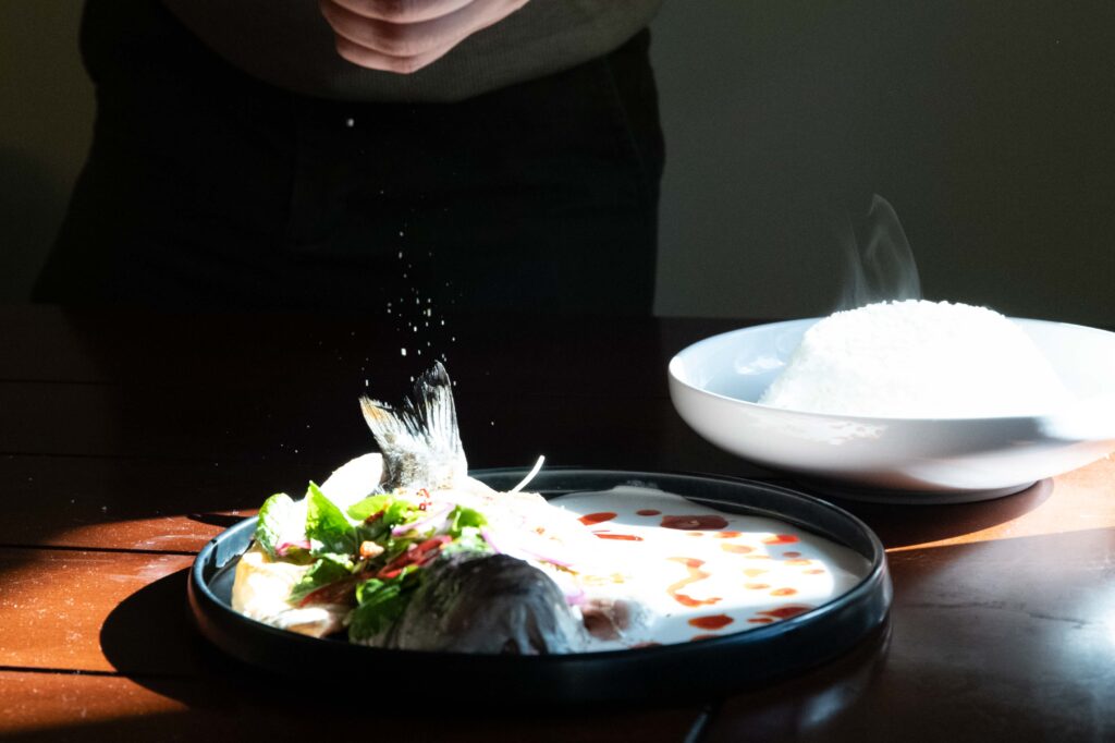 Khan grinds salt as a finishing touch to a dish with layers of flavors. Photographed by Julia Gu/BruinLife.