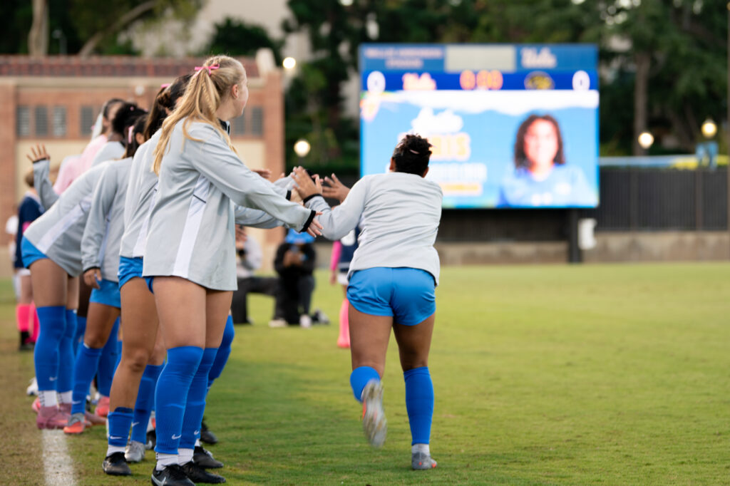 Players get hyped before the start of Womens Soccer game.