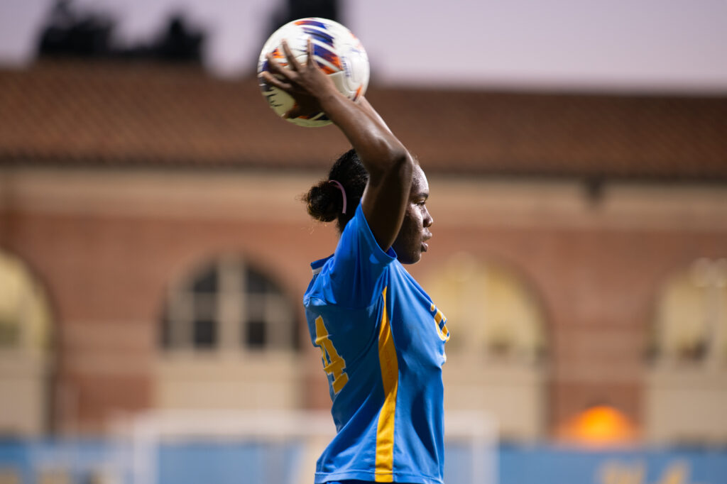 UCLA Player number #24 prepares to over head throw the ball into play.