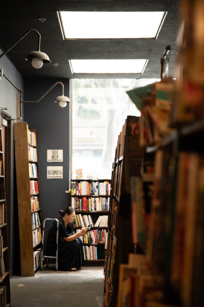 A visitor takes a pause among the book stacks. No corner of The Last Bookstore is the same — this one is among the quieter ones. Photographed by Julia Gu/BruinLife.