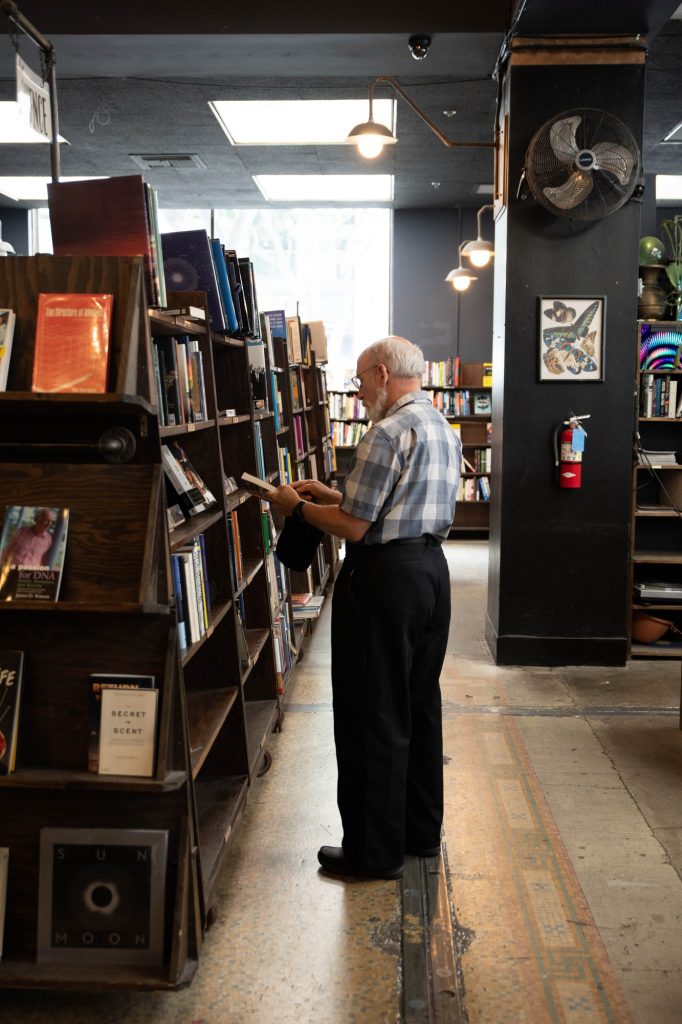 A regular pursues the store's science section. The store's trapezoid-shaped shelves add to its charm. Photographed by Julia Gu/BruinLife.